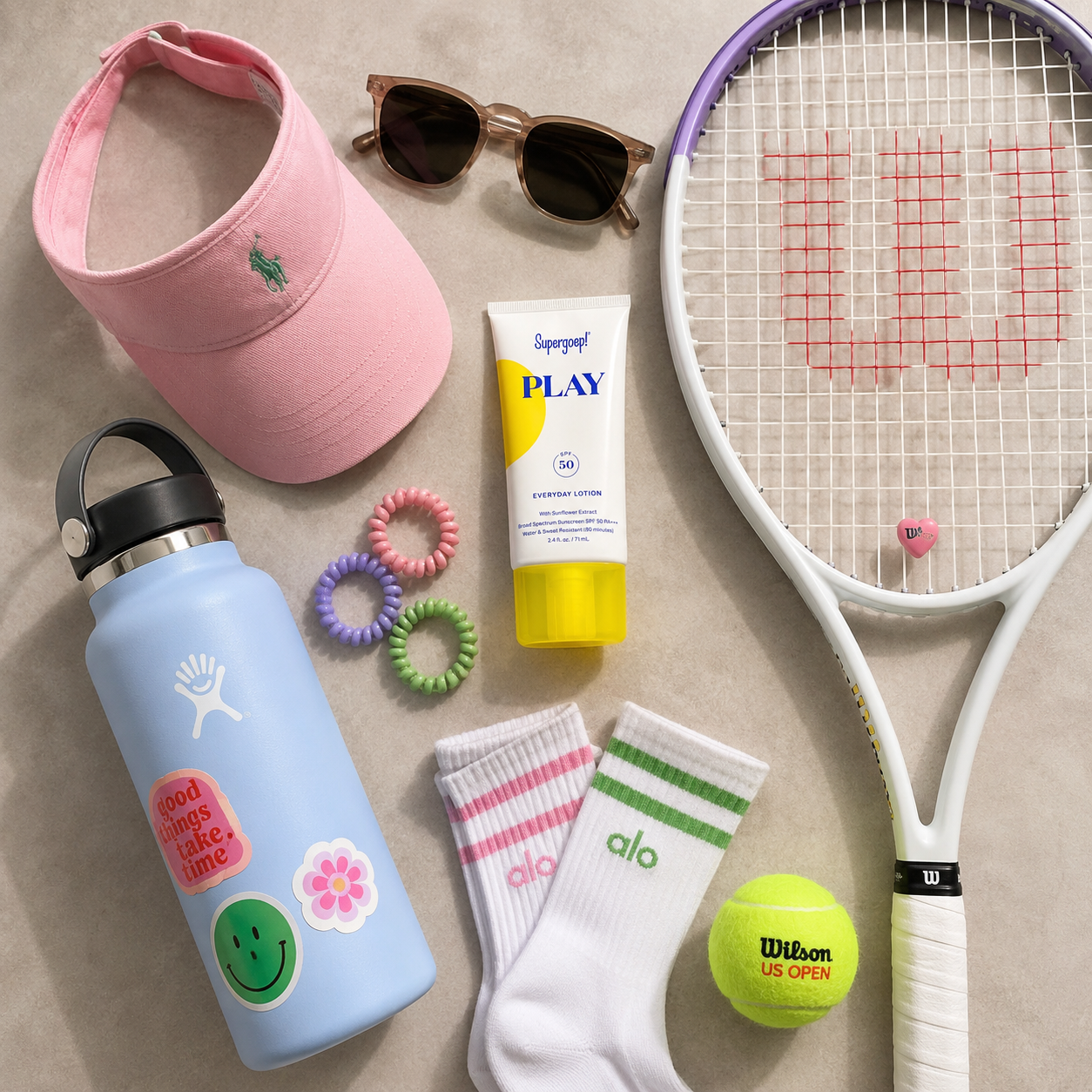 Tennis sun protection essentials including sunscreen, water bottle, visor, racquet, and tennis balls.
